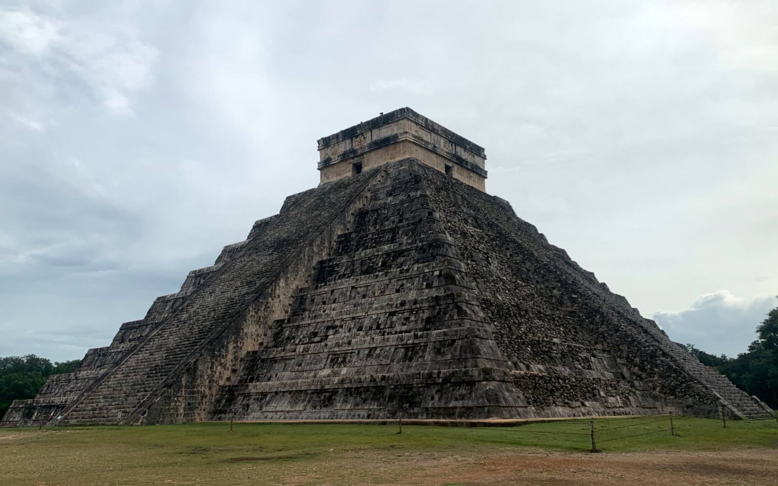 Large, stone pyramid set against a cloudy sky